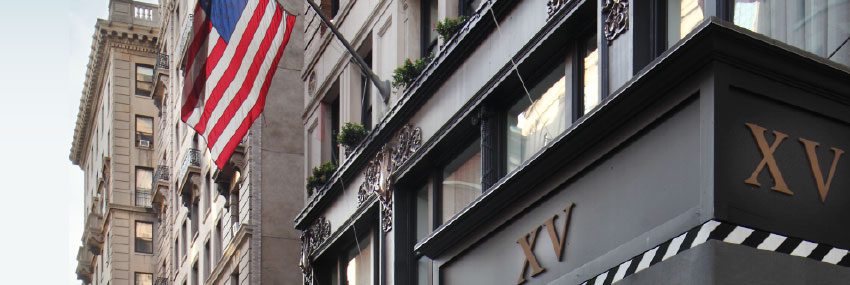 Exterior of the hotel with a close up picture of the fifteen beacon logo