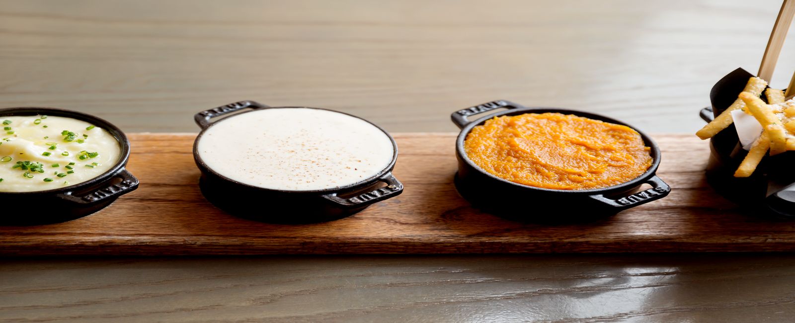 Food Sampling Photograph of our Truffle Fries with three sides to accompany the meal.