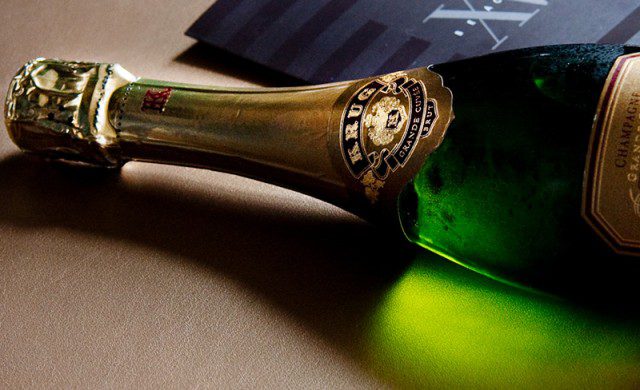 Bottle of our champagne alongside our in-room dining menu