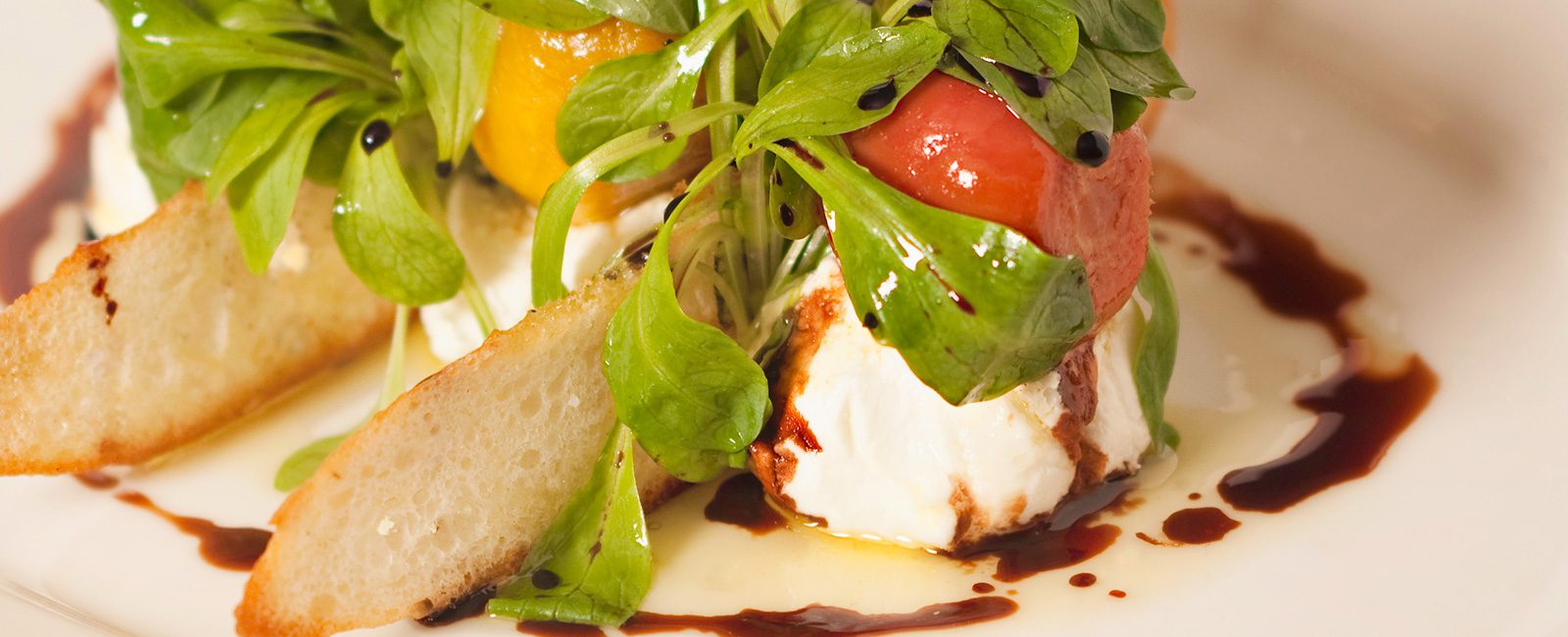 Fresh mozzarella with heirloom tomatoes with balsamic drizzle