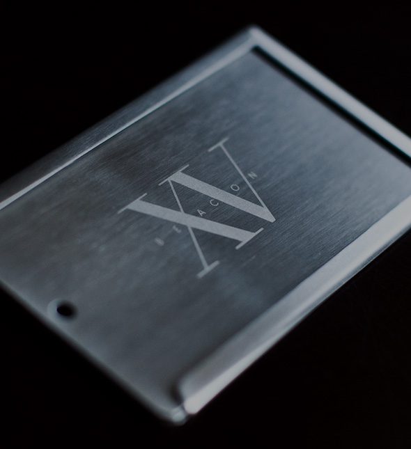 Fifteen beacon business card holder with the hotel's logo in the middle.