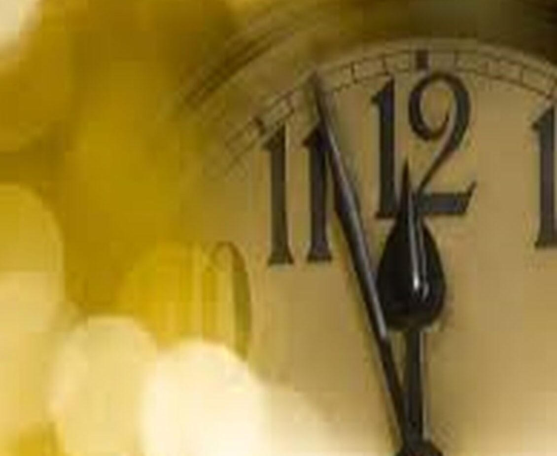 old black and white clock that reads midnight for New Years Eve