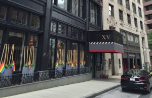Photo of the hotel's exterior with rainbow colored flags outside to support Gay pride