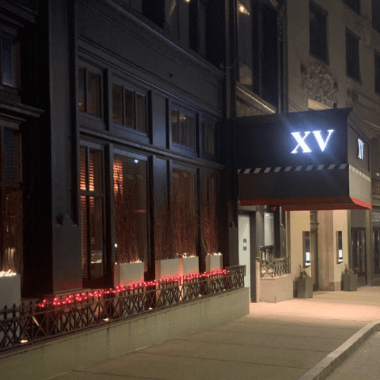 photo of the xv beacon hotel at night with red lights lite