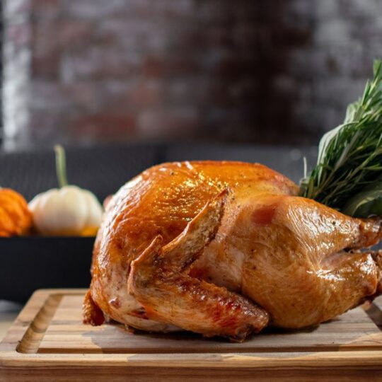 Thanksgiving Turkey with a pumpkin display in the background